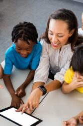 Teacher-using-app-on-a-tablet-wi