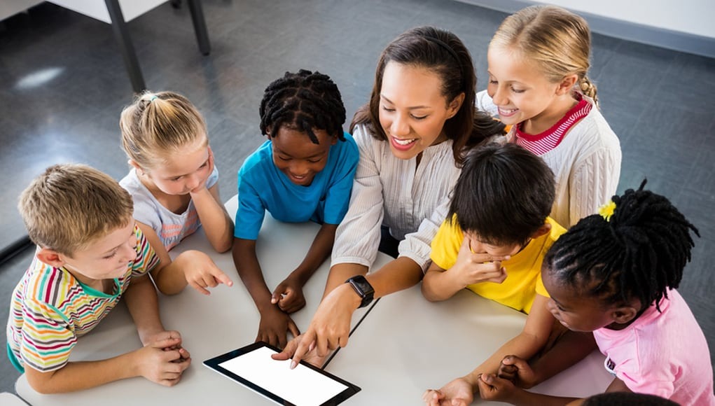 Teacher using app on a tablet wi